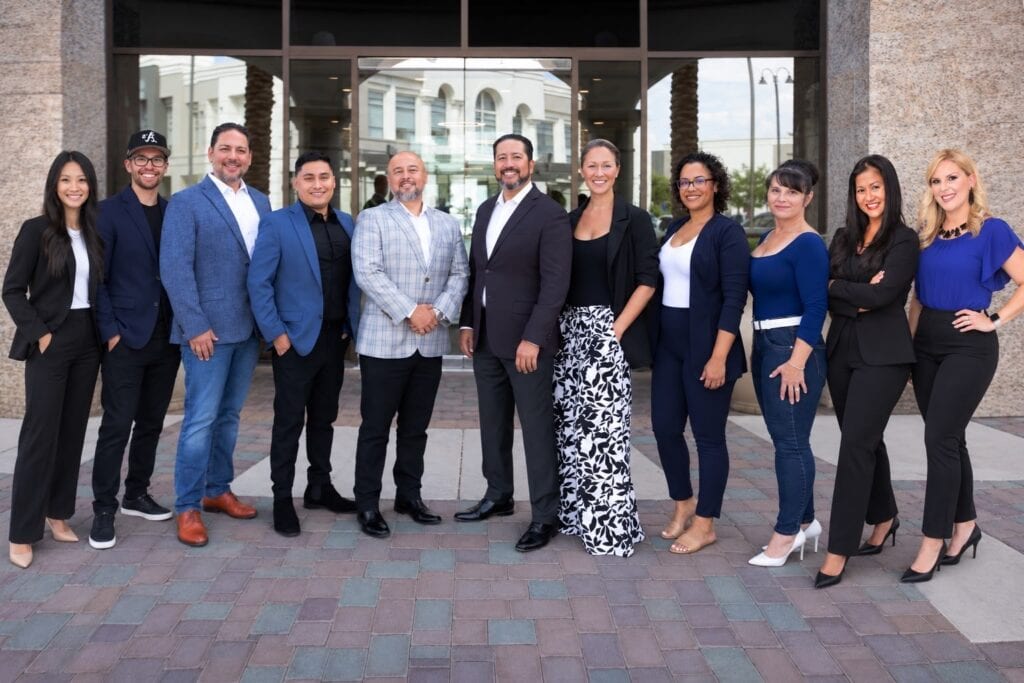 Rick Ruiz & Team standing outside a building in Las Vegas, ready to assist with real estate needs.